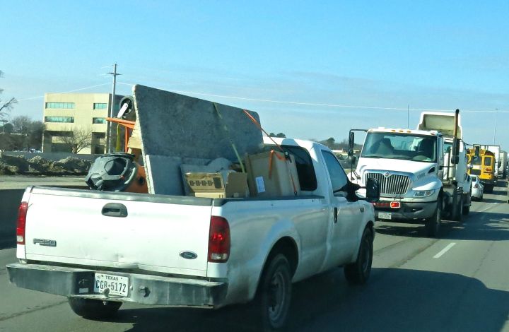 Road construction is a way of the commuting life in Dallas-Fort Worth these days (years). Here in a slow down, I'm thinking this is like some kind of show down - trucks facing each other on a major highway (even though one is being towed)….