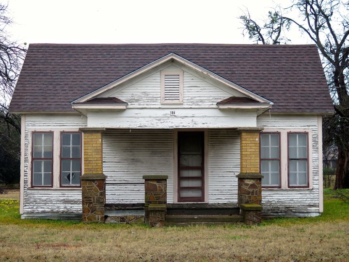 I have watched "this old house" deterriorate for years and figured before it falls in on itself, it was worthy of a photograph. It is odd decisions like this: symmetry in everything except the front door and a porch column that makes me wonder about decisions made in its design and construction many years ago.